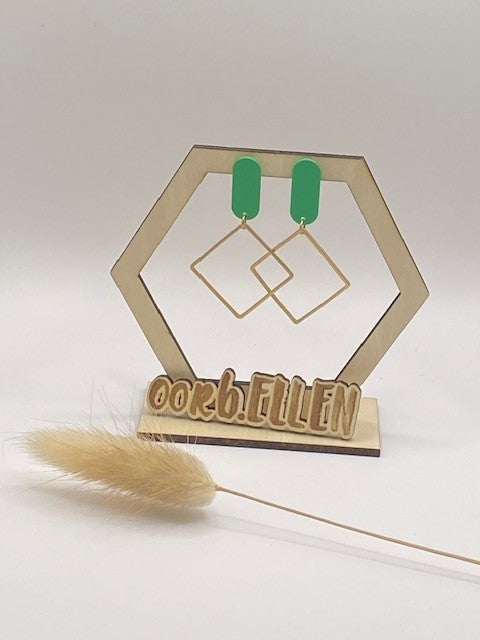 Gouden open vierkanten aan grasgroene ovalen knop